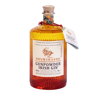 A bottle of Drumshanbo Gunpowder Irish Gin with California Orange Citrus, with a cork stopper and a hanging paper tag, shown on a plain white background.