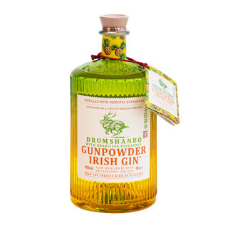 A bottle of Drumshanbo Gunpowder Irish Gin with Brazilian Pineapple, with a cork stopper and a small hanging tag, shown on a plain white background.