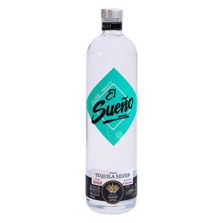 A bottle of El Sueño Tequila Silver on a solid white background. The bottle is clear glass containing a pale silver liquid, featuring a prominent teal diamond-shaped label with black script text and a black neck collar.