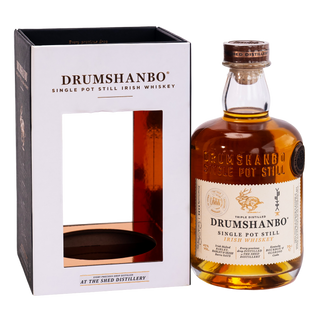 A bottle of Drumshanbo Single Pot Still Scotch Whisky next to its white and black presentation box, set against a plain white background.