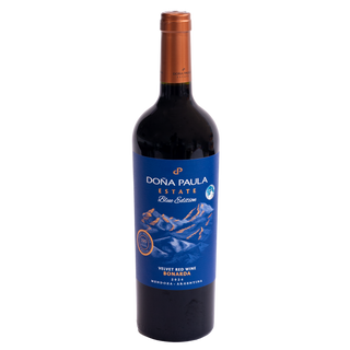 A bottle of Dóna Paula Estate Blue Edition Velvet Red Wine Bonarda, featuring a dark glass bottle with a copper-colored foil capsule and a blue label depicting mountains.