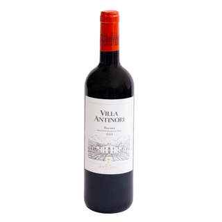 A bottle of Villa Antinori Toscana red wine with a white label and a bright red-orange foil capsule, set against a plain white background.