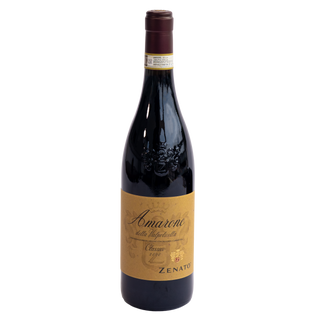 A bottle of Amarone della Valpoticella Classico 2020 from the brand Zenato, featuring a dark glass bottle with a gold label and a dark brown capsule, isolated on a white background.