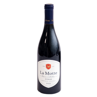 A bottle of La Motte Reserve Collection 2022 Syrah red wine, featuring a dark glass bottle with a white and red label and a dark blue capsule, set against a plain white background.