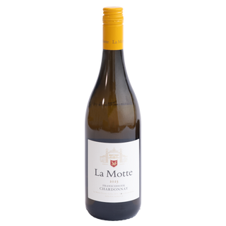 A bottle of La Motte 2023 Franschhoek Chardonnay white wine, featuring a dark glass bottle with a white label and a bright yellow cap, isolated on a white background.