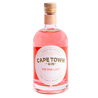 A bottle of Cape Town Gin 'The Pink Lady' with a pink liquid inside, a white oval label, and a cork stopper, shown on a plain white background.